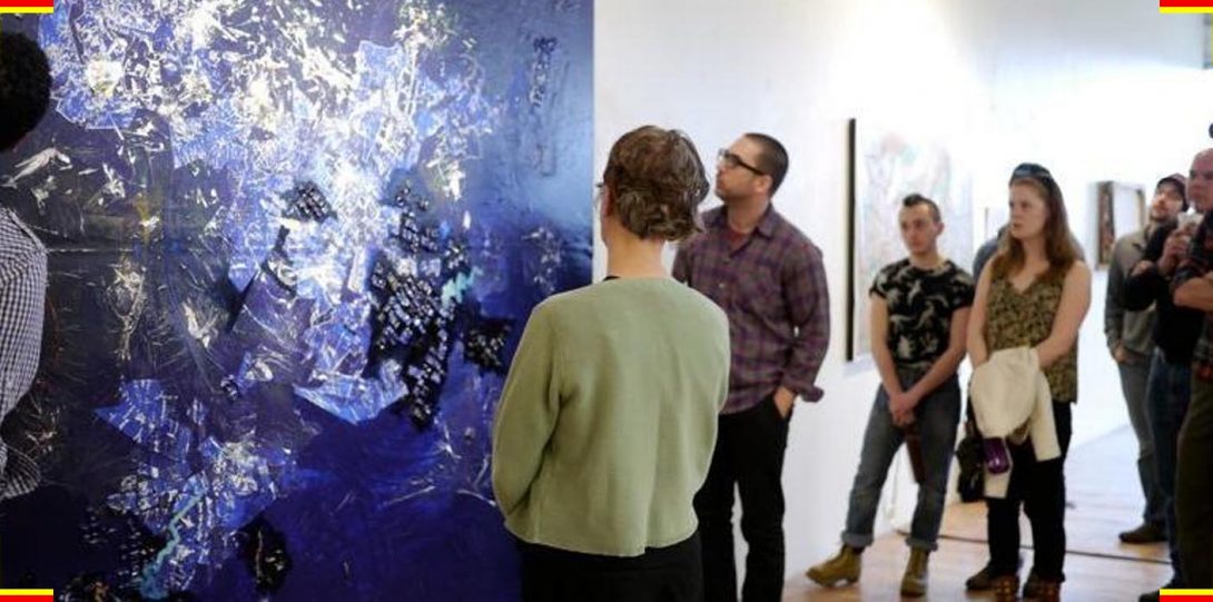 People looking at a painting in a gallery